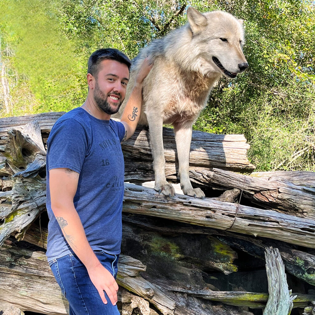 John with a wolf at an animal facility