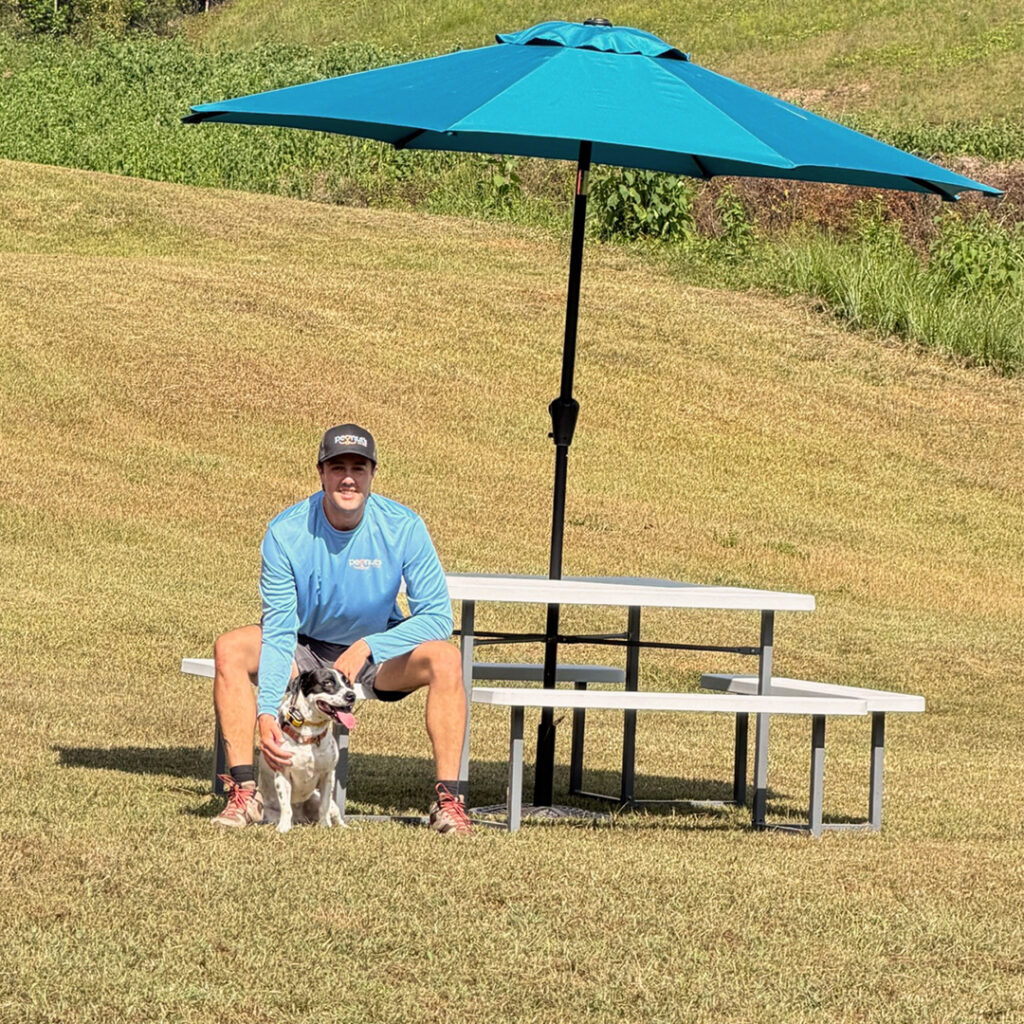 John Hay with his dog Shiloh at the Peanut's Pet Care outdoor training area