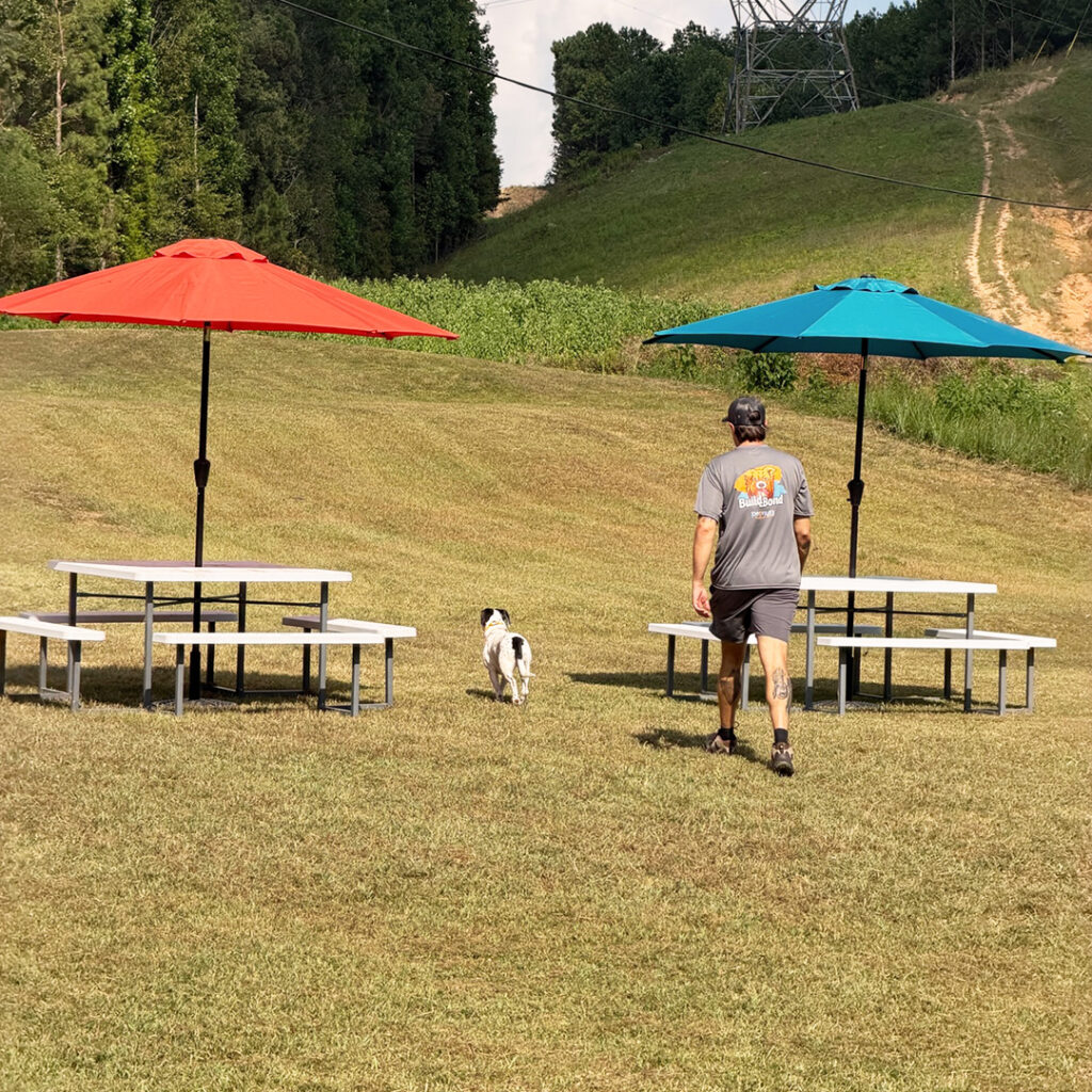 John walking with a dog during a private training session at Peanut's Pet Care