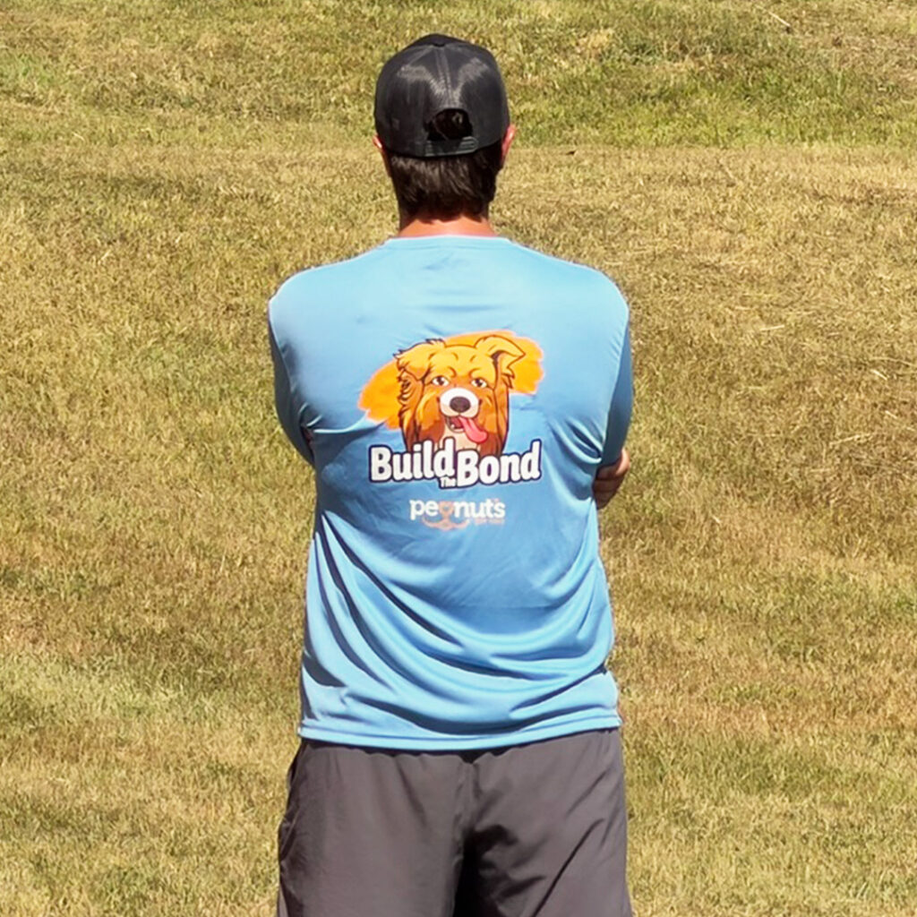 John wearing a Peanut's Pet Care Build the Bond training shirt
