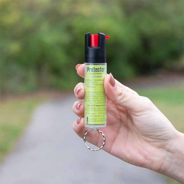 Hand holding Protector dog deterrent pepper spray