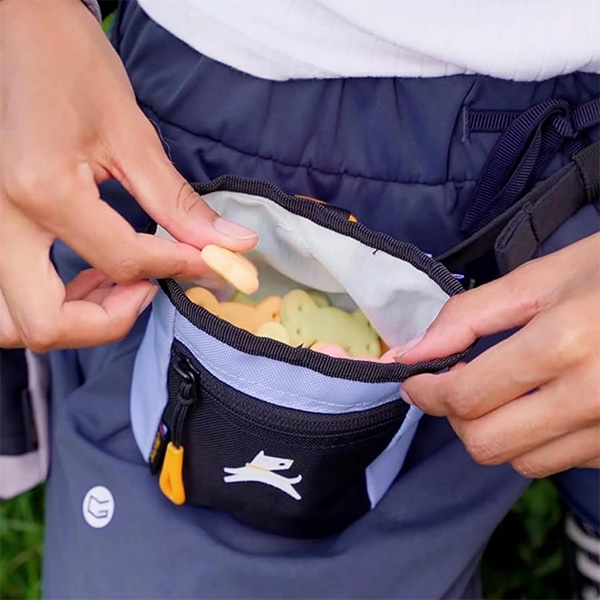 Treat pouch worn around the waist with dog treats inside